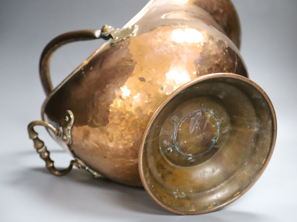 A 19th century planished copper helmet coal scuttle